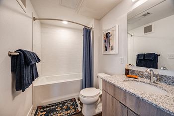 Luxurious bathrooms with walk-in [or tub] showers, large mirrors, and plenty of storage